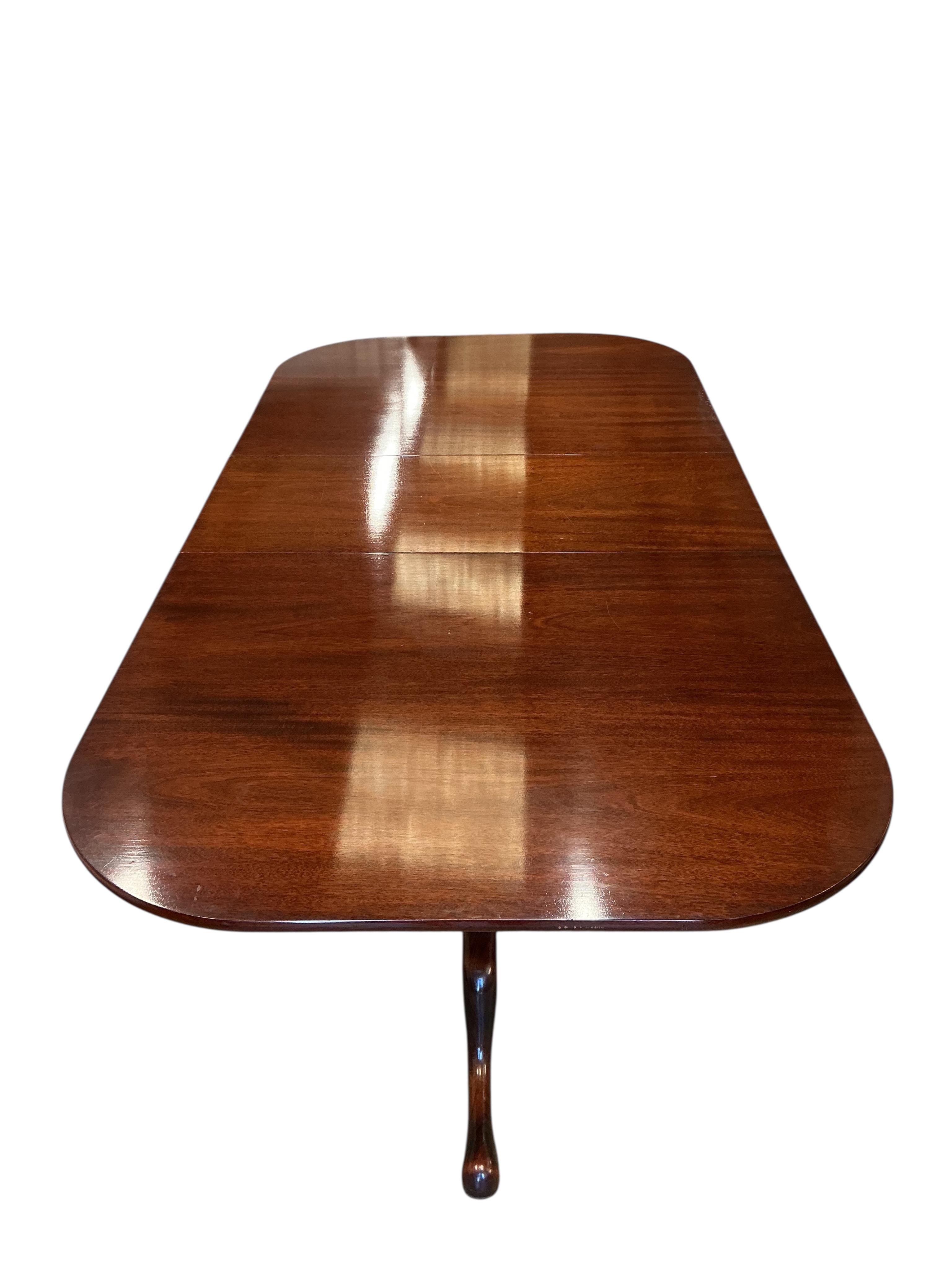 A William Tillman reproduction mahogany twin pillar extending dining table, 225cm extended, one spare leaf, depth 115cm, height 74cm